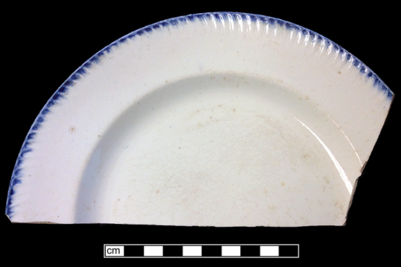Blue edged impressed and unscalloped refined white earthenware plate. Rim diameter: 8.50”, from 18BC27, Feature 30.